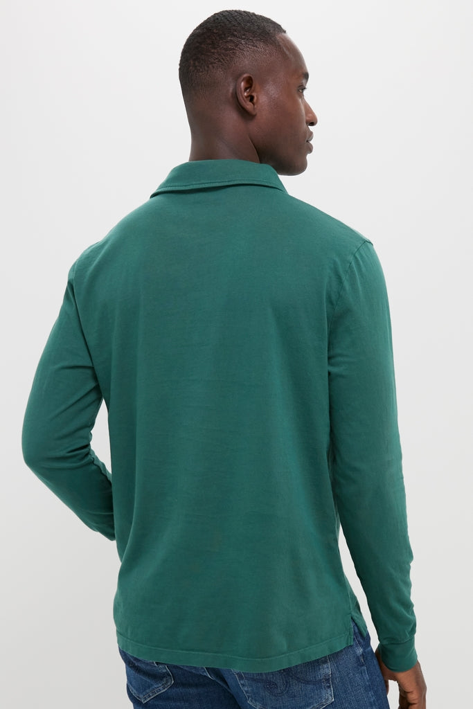 Young man wearing a classic, effortless Washed Pine Long Sleeve Hudson Polo, showcasing a relaxed fit perfect for fun, high-end style with jeans.