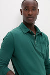 Young man wearing the classic Washed Pine Long Sleeve Hudson Polo in forest-green, showcasing effortless style with its soft Pima cotton and fun, high-end design.
