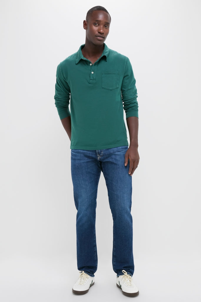 Man wearing Washed Pine Long Sleeve Hudson Polo, embodying classic, effortless style with a soft Pima cotton finish, paired with jeans and sneakers for a high-end, fun look.