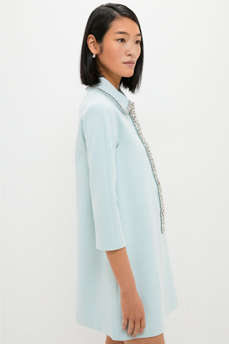 Young woman in profile wearing the classic, effortless Ice Blue Embellished Nicola Dress with sparkly trim and a boxy fit, exuding high-end style.