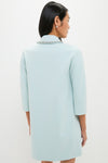 Woman in a classic, effortless Ice Blue Embellished Nicola Dress with three-quarter sleeves, showcasing a decorative neckline trim, embodying a high-end, fun style.