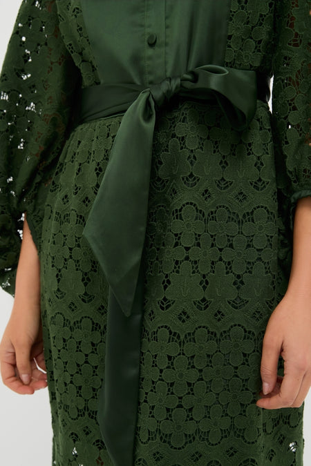 Forest Green Lace Calliope Dress features classic floral lace, an effortless satin bow at the waist, and a fun, high-end design perfect for any occasion.
