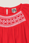 Red Nala Dress: A classic, effortless children’s outfit featuring a gathered neckline, white embroidery, and keyhole closure, perfect for a fun, high-end look.