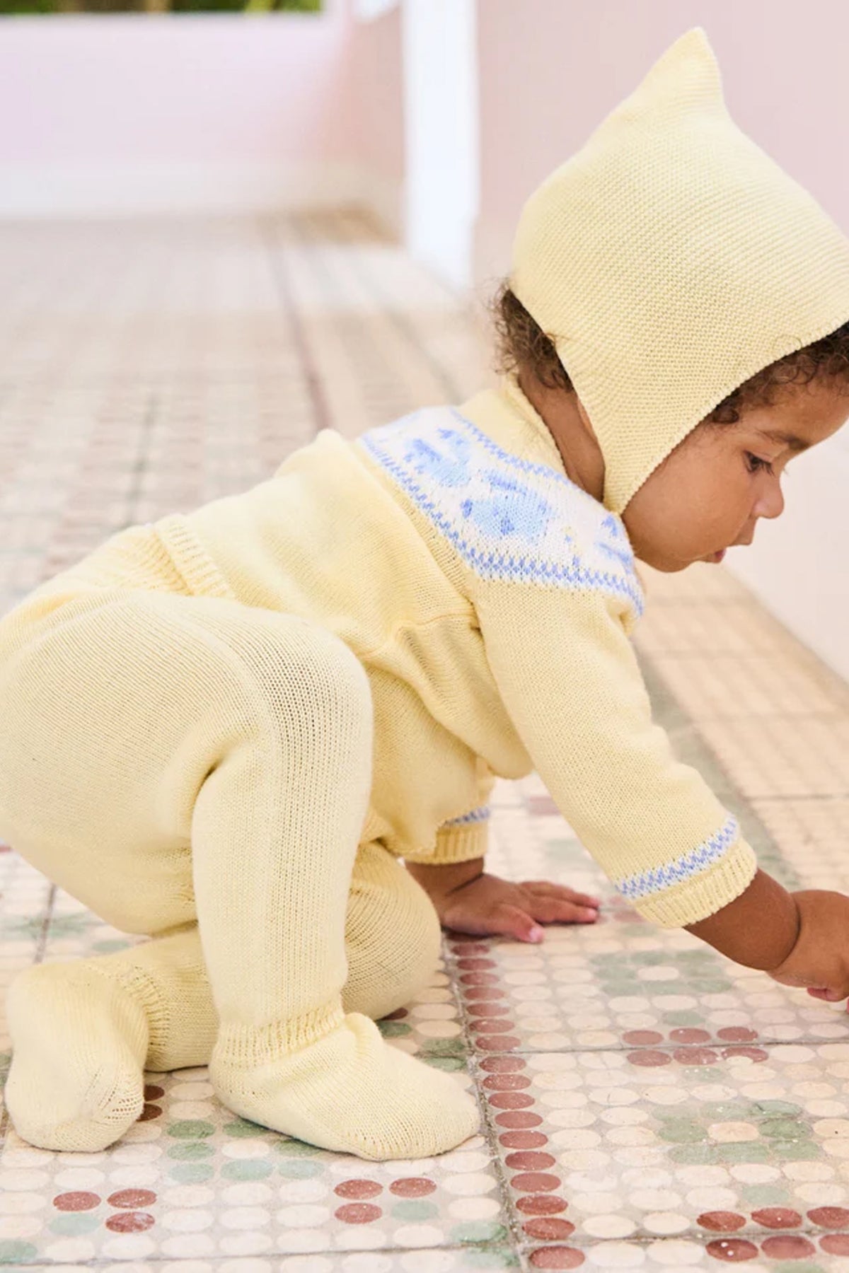 Infant in classic Lemon Kayra Cotton Baby Knitted Set, effortlessly exploring. Features intarsia motifs and footed leggings for high-end fun and comfort.