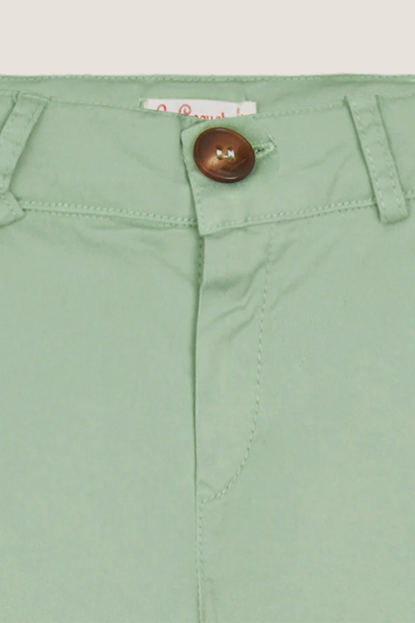 Close-up of Sage Green Elio Chinos waistband, showcasing classic button closure, belt loops, and tailored details for an effortless, high-end, and fun look.