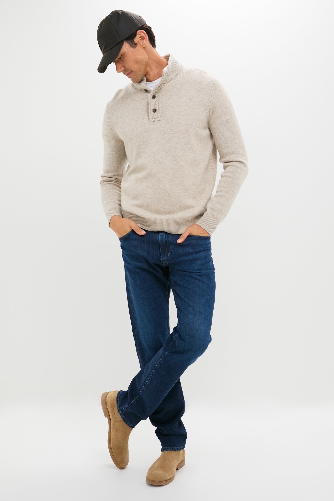 Model in classic Graduate Jean, Crusade Wash Denim (32 Inseam), paired with a light-beige knit sweater and tan suede Chelsea boots, embodies effortless, high-end style.