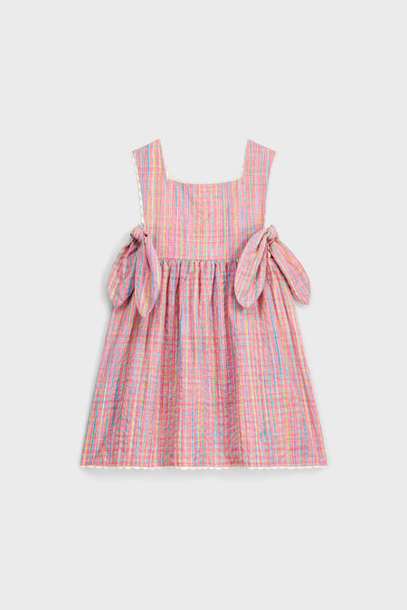 Classic Pink Pomelo Checks Aloisa Dress features an effortless apron design with fun self-ties and high-end ric-rac trim, perfect for stylish spring outings.