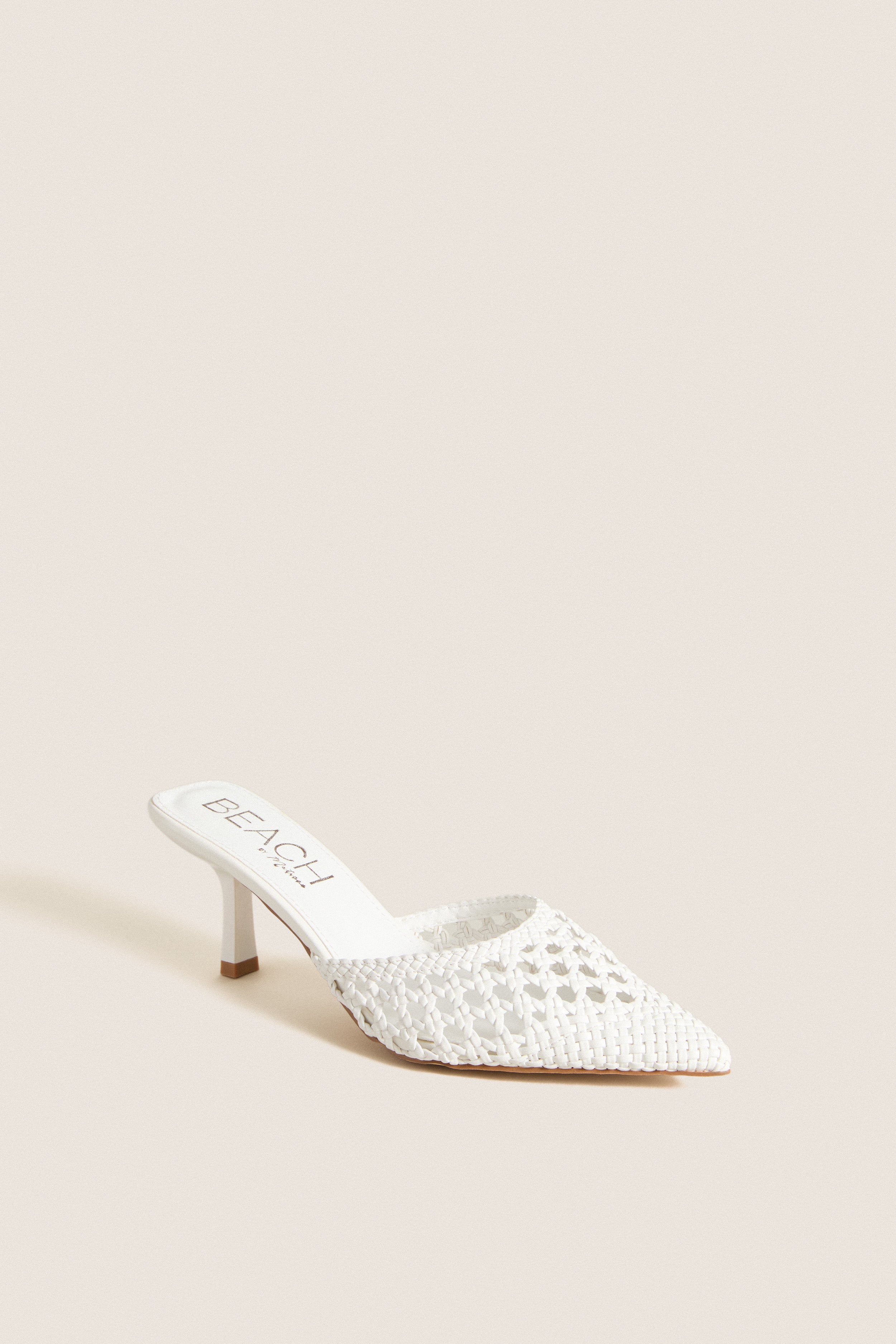 White Tia Heels: Classic, high-end mule with a woven, pointed-toe design and comfortable kitten heel, embodying effortless style for fun, versatile fashion.
