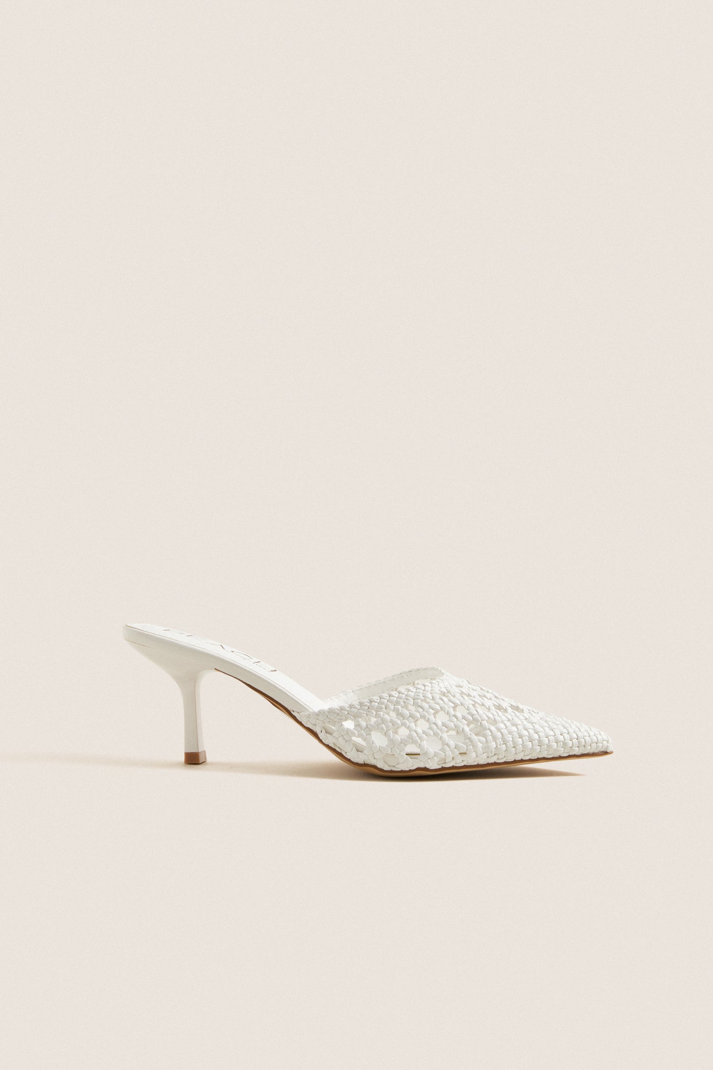 White Tia Heels: Classic mule with woven texture, pointed toe, and kitten heel. Effortless style for high-end looks, perfect for fun summer events and everyday elegance.