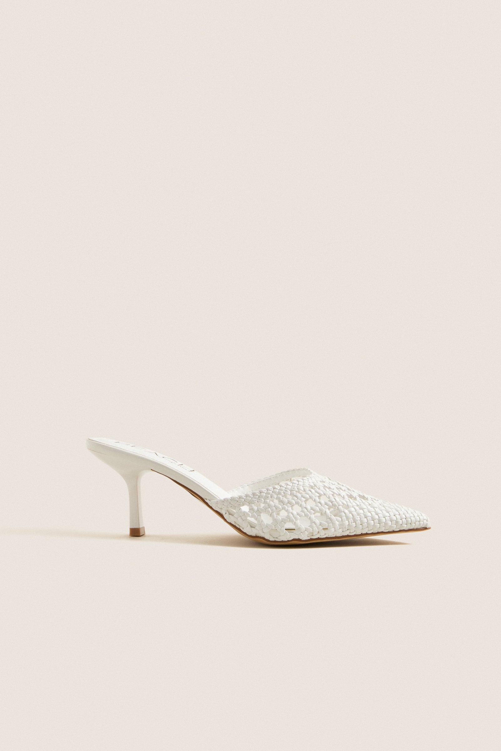 White Tia Heels: Classic mule with woven texture, pointed toe, and kitten heel. Effortless style for high-end looks, perfect for fun summer events and everyday elegance.