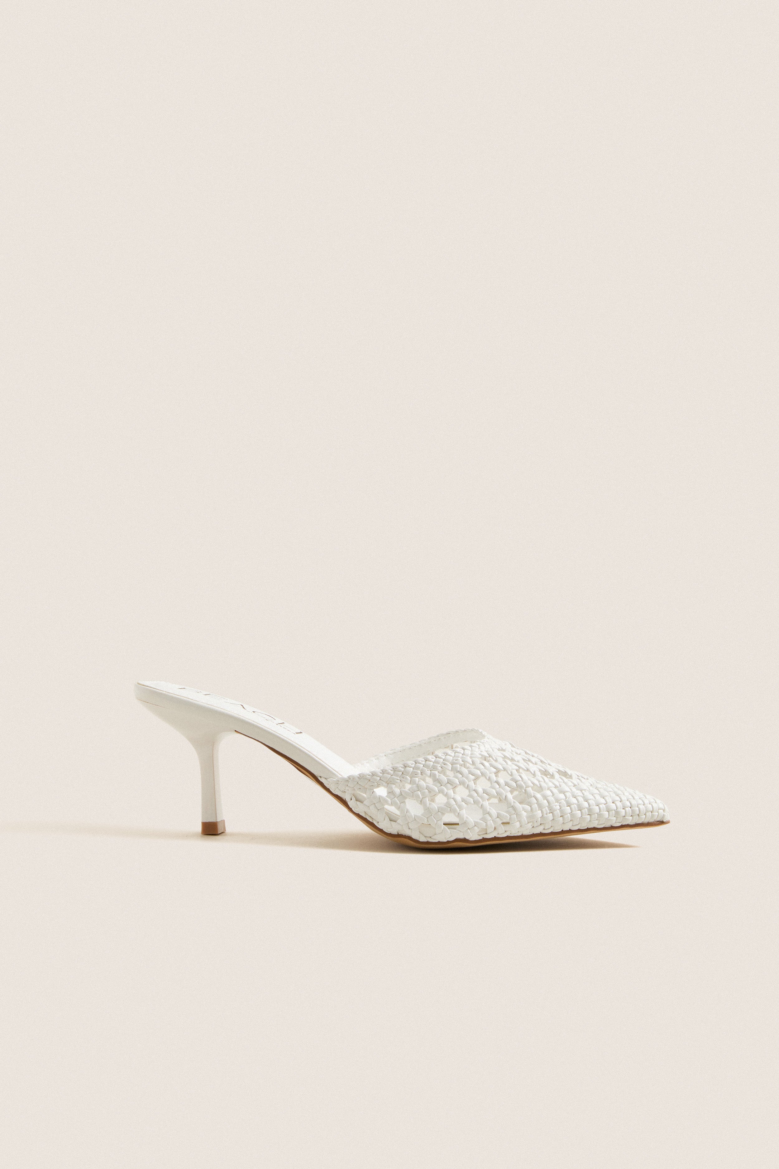 White Tia Heels: Classic mule with woven texture, pointed toe, and kitten heel. Effortless style for high-end looks, perfect for fun summer events and everyday elegance.