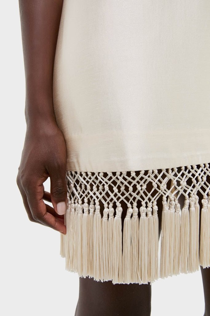 Effortlessly chic, the Winter White Tassel Dupioni Downing Dress features a classic shift silhouette with fun fringe hem, epitomizing high-end elegance for festive occasions.