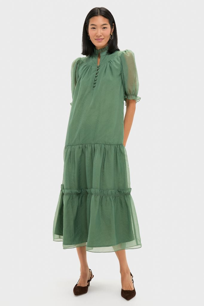 Effortlessly model a classic, high-end Green Chiffon Selena Maxi Dress with romantic ruffles, puff sleeves, and a tiered skirt, ideal for fun cocktail events.