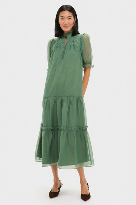 Effortlessly model a classic, high-end Green Chiffon Selena Maxi Dress with romantic ruffles, puff sleeves, and a tiered skirt, ideal for fun cocktail events.