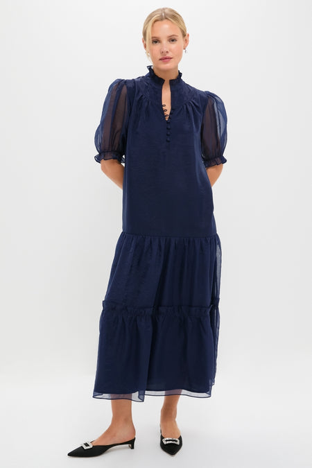 Navy Chiffon Selena Maxi Dress with classic ruffle collar, sheer puff sleeves, tiered skirt; effortlessly combines fun and high-end style for any occasion.