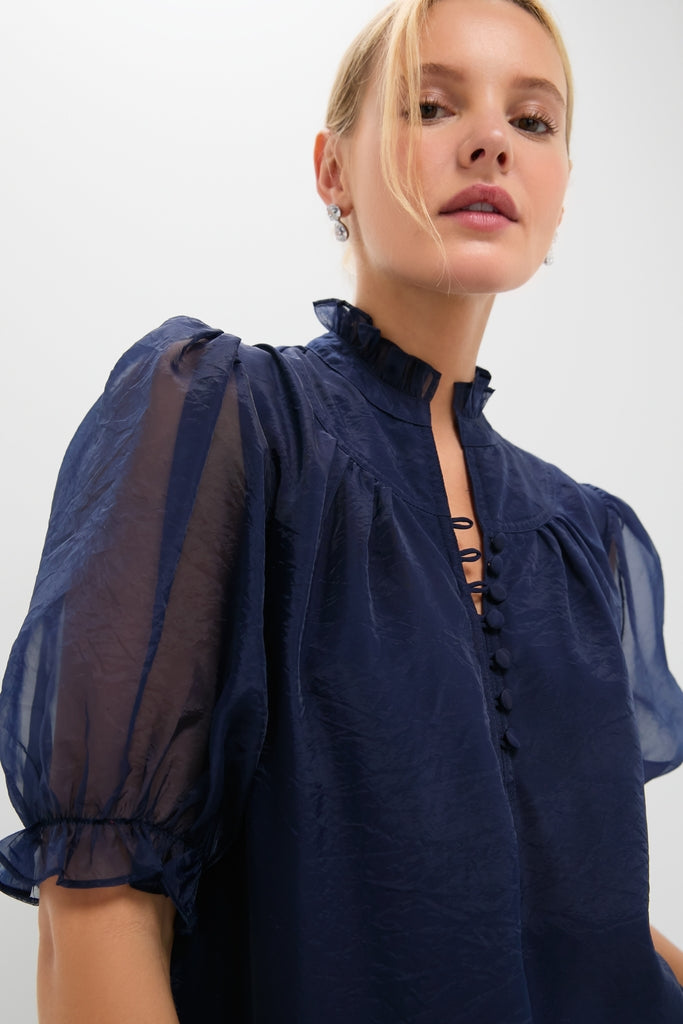 Woman wearing the Navy Chiffon Selena Maxi Dress, showcasing a classic, effortless style with a high ruffled collar, puff sleeves, and fun, high-end detailing.