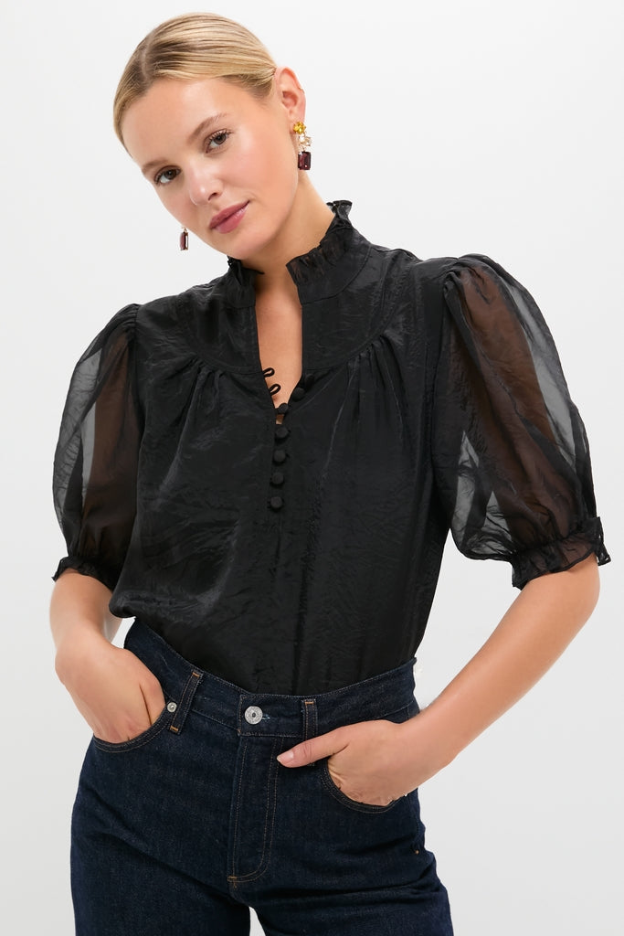 Black Chiffon Selena Blouse features sheer puff sleeves, ruffle stand collar, and covered buttons, creating a classic, effortless, and fun high-end look.