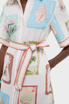 Coastline Shirt Dress with colorful stamp illustrations, featuring a classic button-front and effortless sash tie at the waist. Perfect for a fun, high-end look.