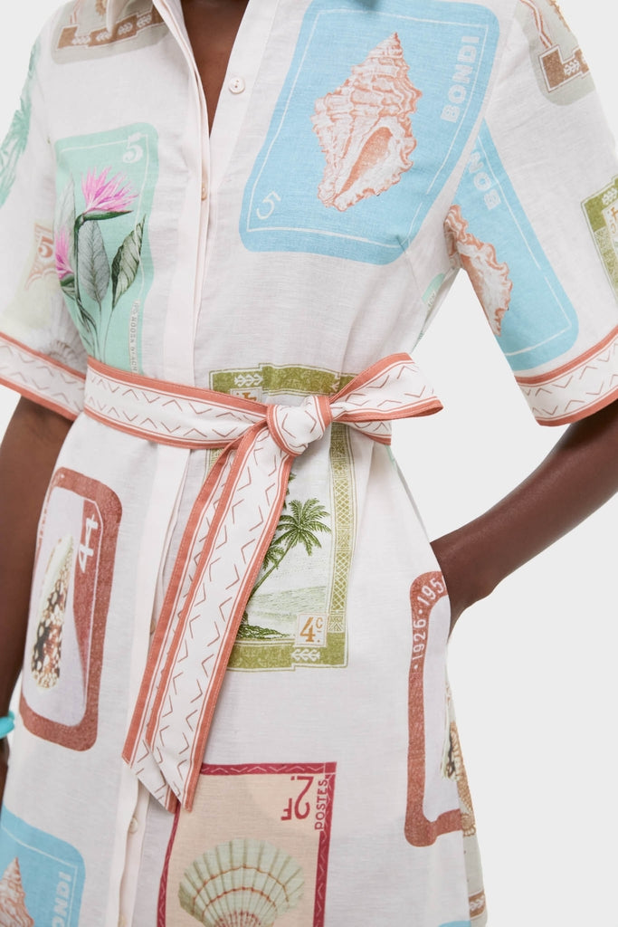 Coastline Shirt Dress with colorful stamp illustrations, featuring a classic button-front and effortless sash tie at the waist. Perfect for a fun, high-end look.