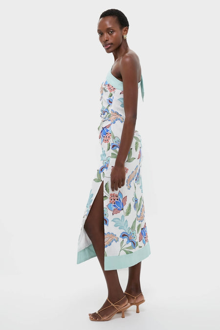 Azure One-Shoulder Midi Dress with vibrant florals, classic thigh-high slit, and mint-green hem, exudes effortless, high-end style; paired with strappy sandals and gold hoops.