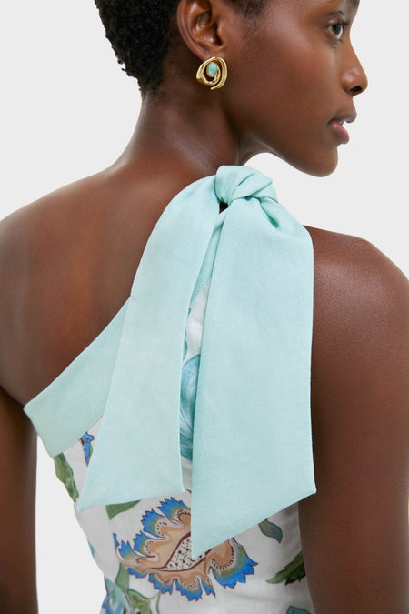 Azure One-Shoulder Midi Dress features a floral print with a mint green bow strap, exuding classic, effortless elegance. Paired with a high-end, fun gold-tone earring.