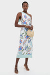 Model wears the Azure One-Shoulder Midi Dress, featuring an effortless floral design with a mint-green strap, paired with a classic straw handbag and gold-tone jewelry, embodying high-end fun.