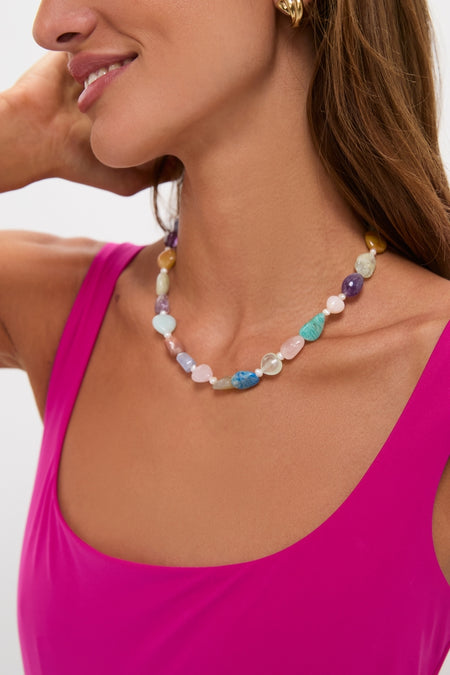 Woman wearing a classic, fun multi-colored beaded necklace and fuchsia top, embodying effortless style and high-end fashion, reflecting the Berry Dreamsculpt Square Neck Tank One Piece's essence.