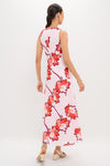 Woman models Lani Maxi Dress, a classic A-line sleeveless piece with vibrant floral print, twist bodice detail; styled with sandals and gold accessories for an effortless, high-end look.