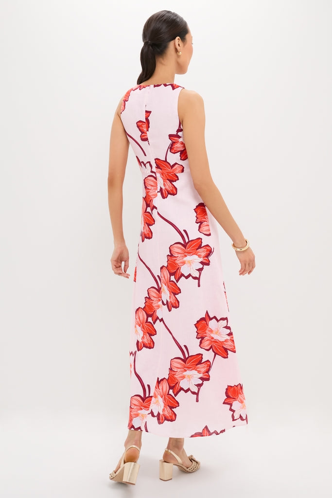 Woman models Lani Maxi Dress, a classic A-line sleeveless piece with vibrant floral print, twist bodice detail; styled with sandals and gold accessories for an effortless, high-end look.