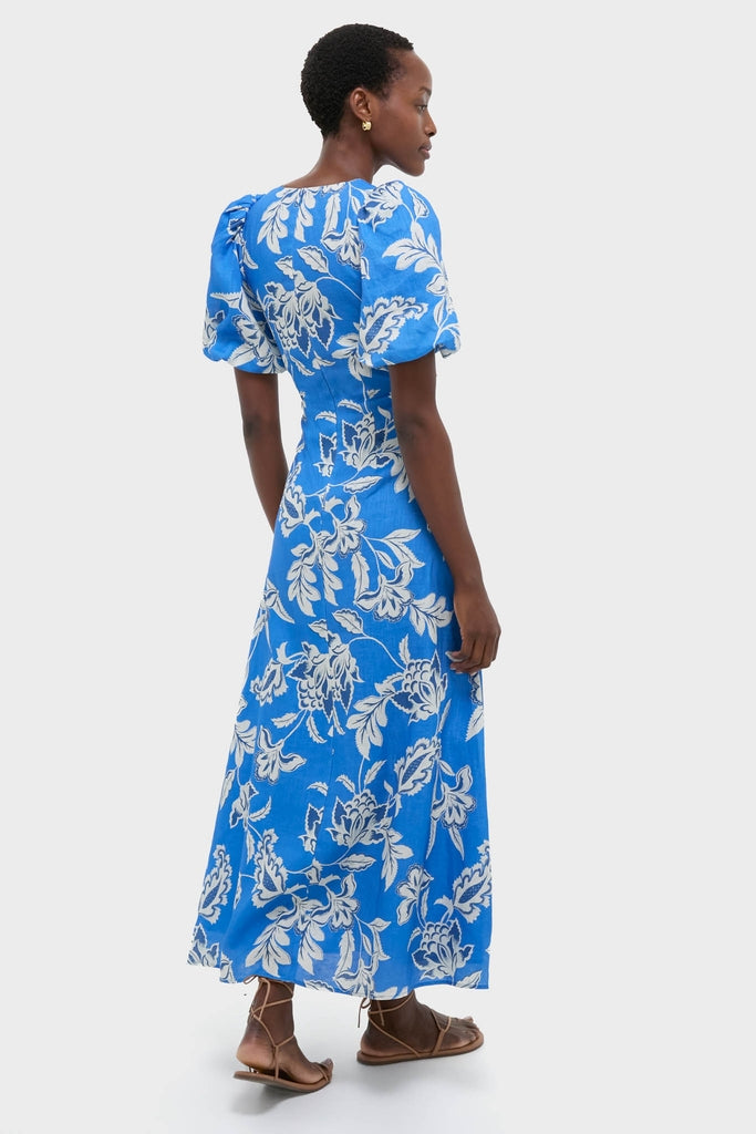 Ren Cut Out Maxi Dress with short puff sleeves and floral motifs exudes classic, effortless style, paired with brown strappy sandals and gold hoops for a fun, high-end look.