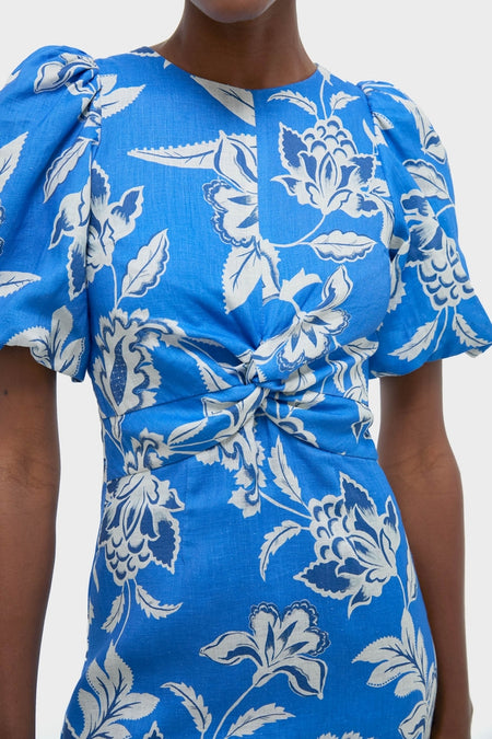 Ren Cut Out Maxi Dress with classic oversized floral motifs, featuring an effortless twist detail at the waist and fun puffed sleeves, reflecting a high-end, confident style.