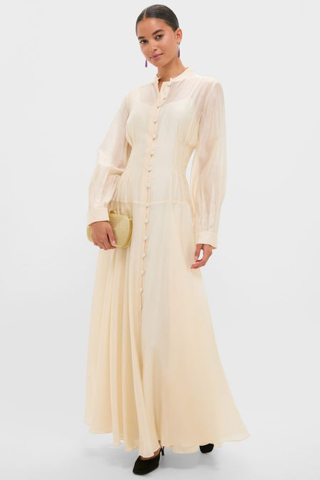 Champagne Organza Marbella Dress exudes classic elegance with sheer blouson sleeves, pintuck bodice, and Mandarin collar, creating an effortless, high-end look perfect for fun occasions.