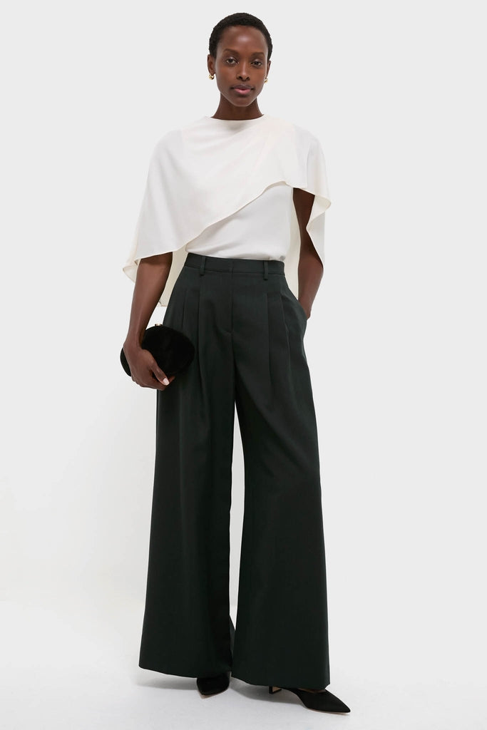 Cream Eliora Cape Top: Effortlessly chic, this high-end, classic top features an asymmetric drape, exuding modern elegance. Perfectly paired with wide-leg trousers for a fun, elevated look.