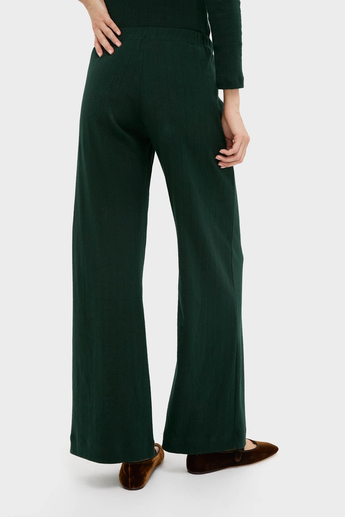 Back view of classic Forest Pointelle Boxer Pants in a relaxed silhouette, showcasing effortless style with an elastic waistband and wide-leg design, paired with elegant brown velvet flats.
