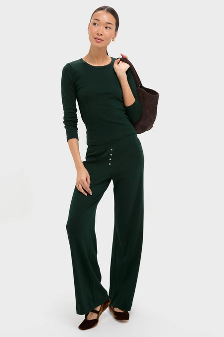 Model in a classic, effortless deep forest-green loungewear set, featuring the Forest Pointelle Boxer Pants with decorative buttons, styled with high-end accessories for a fun look.
