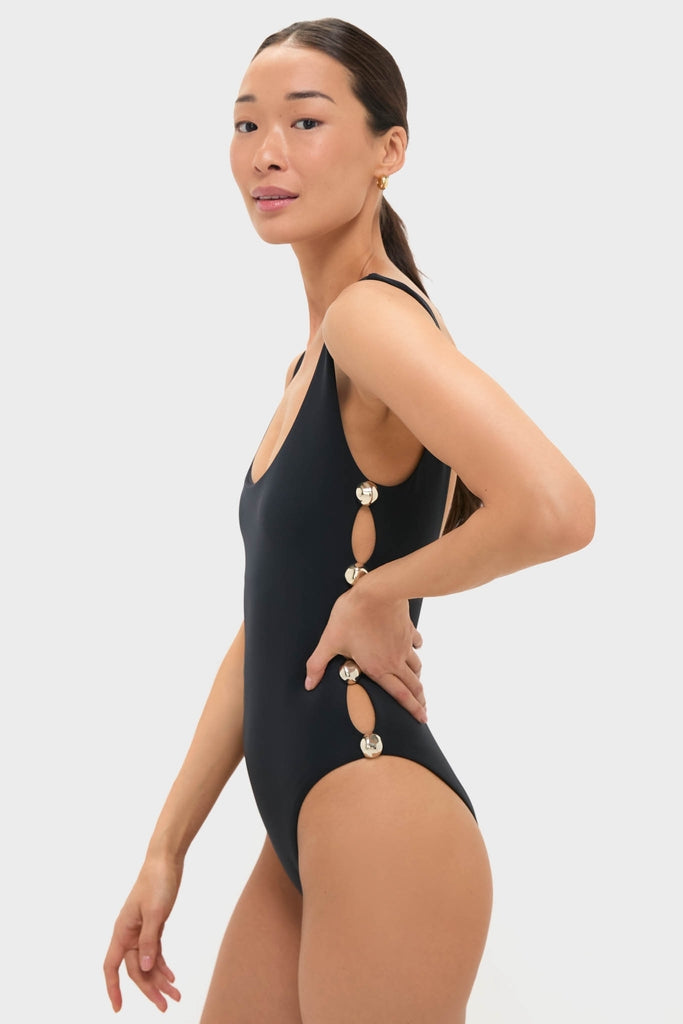 Model wearing the Black Mona Scoop Neck One Piece with sleek side cut-outs and silver-tone rings, showcasing an effortless, high-end look that exudes classic fun and sophistication.
