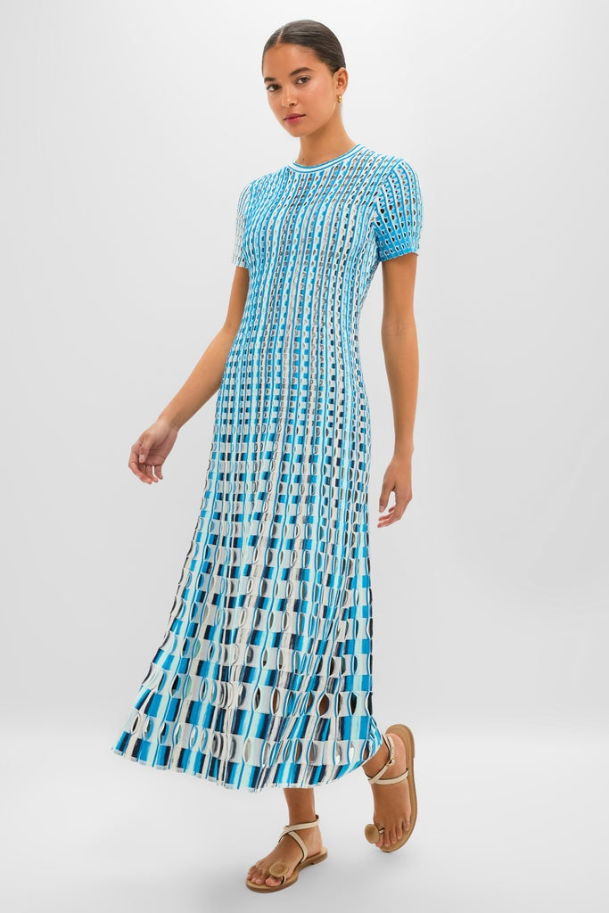 Azure Multi Zaida Midi Dress: A classic, effortless knit dress with a geometric stripe pattern, showcasing a fun, high-end A-line silhouette, paired with tan leather sandals.