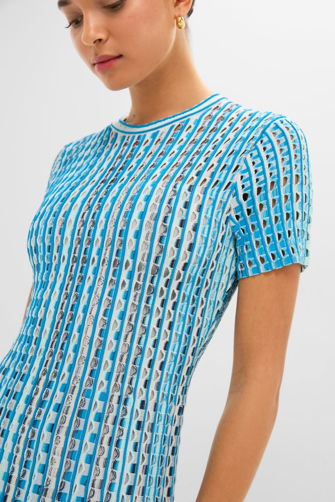 Woman modeling the Azure Multi Zaida Midi Dress, a classic, high-end knit with geometric cutouts, featuring an effortless A-line silhouette and fun vertical stripes.