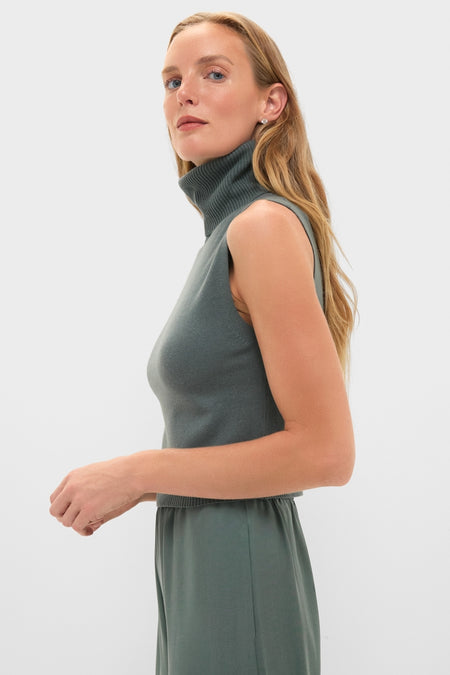 Eucalyptus Zoe Sleeveless Turtleneck: A classic, effortless high-end piece, showcasing a sleeveless, ribbed turtleneck design, perfect for a fun, modern monochromatic style.