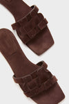Cacao Simkhai Monogram Suede Flat Slides: classic brown suede mules with an open-toe, squared-off design and decorative strap, offering effortless fun and high-end style.
