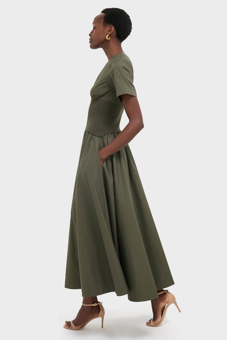 Model in Fern Wrenna Short Sleeve Midi Dress, showcasing a classic, effortless look with its ribbed midsection and gathered skirt, styled with fun, high-end nude sandals.