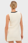 White Knit Lalia Mini Dress features classic crochet trim and an effortless fit, perfect for high-end vacations. Modeled with simple gold accessories for a fun, stylish look.