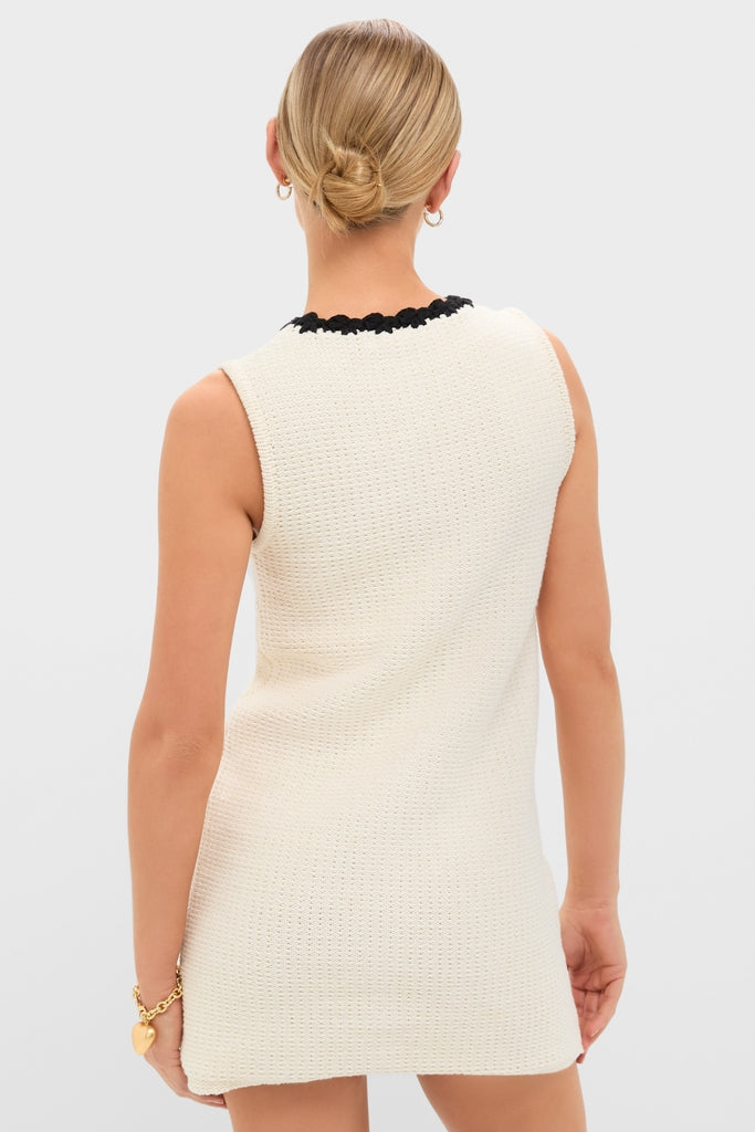 White Knit Lalia Mini Dress features classic crochet trim and an effortless fit, perfect for high-end vacations. Modeled with simple gold accessories for a fun, stylish look.