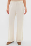 Creme Barb Wide Leg Pants in Japanese-crafted satin, featuring an elastic waistband and relaxed fit, paired with tan ballet flats for a classic, effortless look.