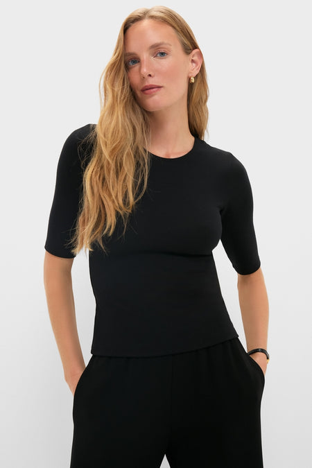 Woman wears Black Lauren Mid Sleeve Tee, a classic, effortless top with elbow-length sleeves, ideal for versatile styling; embodies fun, high-end fashion for any occasion.