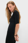 Young woman in profile wearing the classic Black Lauren Mid Sleeve Tee, showcasing its effortless, high-end style with elbow-length sleeves and a crew neckline.