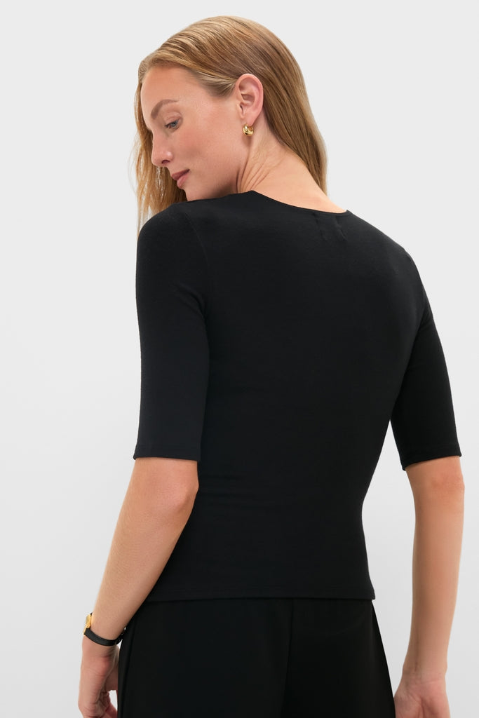 Woman wearing Black Lauren Mid Sleeve Tee with fitted elbow-length sleeves and crewneck, embodying classic, effortless style. Includes gold hoops and wristwatch, reflecting high-end, fun fashion.