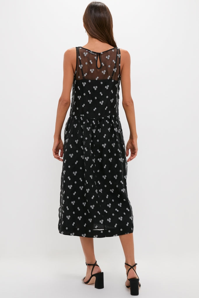 Classic Black Embroidered Mariella Midi Dress with sheer mesh yoke, light dot pattern, and keyhole button detail. Paired effortlessly with high-end block-heeled sandals for a fun, confident look.