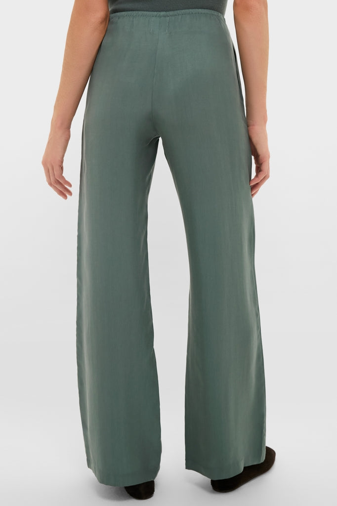 Eucalyptus Kim Pocket Pants in muted green, high-waisted and wide-leg with an elastic waistband, offering a classic and effortless style for a fun, high-end look.
