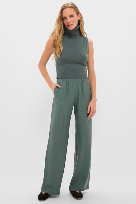 Woman models Eucalyptus Kim Pocket Pants, effortlessly styled with a sleeveless turtleneck. The classic, high-end look captures Tuckernuck's fun and confident fashion essence.